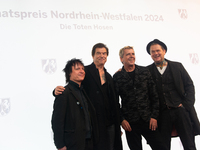 Stephen George Ritchie, Andreas Frege alias Campino, Andreas Meurer, and Andrea, members of the rock band Die Toten Hosen, pose for pictures...