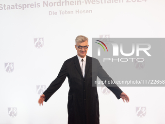 Wim Wenders, a German filmmaker, poses for pictures on the red carpet of Roncalli's Apollo Variety Theatre in Duesseldorf, Germany, on Octob...