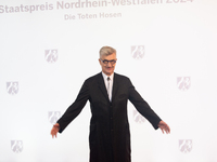 Wim Wenders, a German filmmaker, poses for pictures on the red carpet of Roncalli's Apollo Variety Theatre in Duesseldorf, Germany, on Octob...