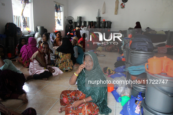 Rohingya refugees rest in a temporary shelter at the Pantai Labu District Office in Deli Serdang Regency, North Sumatra, Indonesia, on Octob...