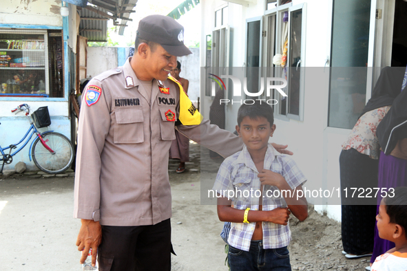 A policeman guards a temporary shelter for Rohingya refugees at the Pantai Labu District Office in Deli Serdang Regency, North Sumatra, Indo...