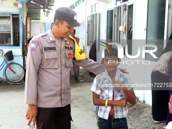 A policeman guards a temporary shelter for Rohingya refugees at the Pantai Labu District Office in Deli Serdang Regency, North Sumatra, Indo...