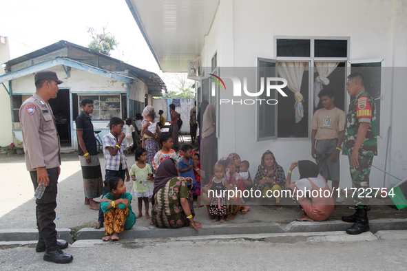 Police and TNI guard a temporary shelter for Rohingya refugees at the Pantai Labu District Office in Deli Serdang Regency, North Sumatra, In...