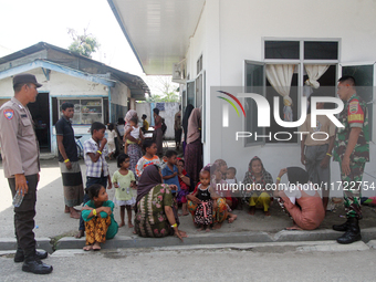 Police and TNI guard a temporary shelter for Rohingya refugees at the Pantai Labu District Office in Deli Serdang Regency, North Sumatra, In...