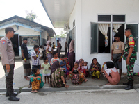 Police and TNI guard a temporary shelter for Rohingya refugees at the Pantai Labu District Office in Deli Serdang Regency, North Sumatra, In...