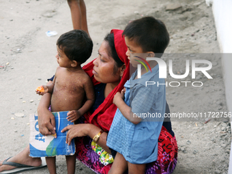 Two Rohingya refugee children and their mother are in a temporary shelter for Rohingya refugees at the Pantai Labu District Office in Deli S...