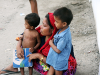 Two Rohingya refugee children and their mother are in a temporary shelter for Rohingya refugees at the Pantai Labu District Office in Deli S...