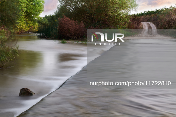 A peaceful scene of the Ofanto River near San Ferdinando di Puglia, Italy, on October 8, 2020, shows a vehicle crossing point. This stretch...