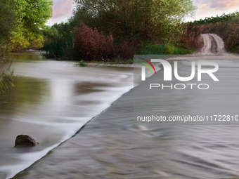 A peaceful scene of the Ofanto River near San Ferdinando di Puglia, Italy, on October 8, 2020, shows a vehicle crossing point. This stretch...