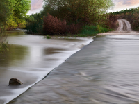 A peaceful scene of the Ofanto River near San Ferdinando di Puglia, Italy, on October 8, 2020, shows a vehicle crossing point. This stretch...