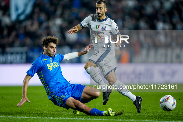 Saba Goglichidze of Empoli FC and Henrikh Mkhitaryan of FC Internazionale compete for the ball during the Serie A Enilive match between Empo...