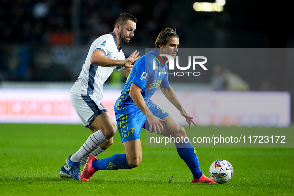 Lorenzo Colombo of Empoli FC and Stefan de Vrij of FC Internazionale compete for the ball during the Serie A Enilive match between Empoli FC...