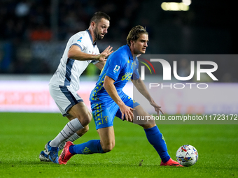 Lorenzo Colombo of Empoli FC and Stefan de Vrij of FC Internazionale compete for the ball during the Serie A Enilive match between Empoli FC...