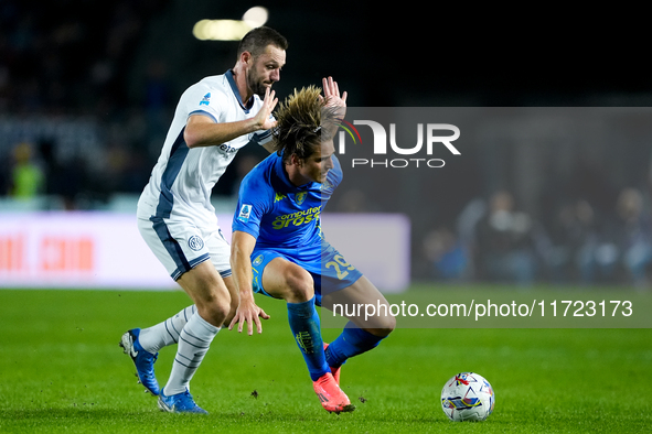 Lorenzo Colombo of Empoli FC and Stefan de Vrij of FC Internazionale compete for the ball during the Serie A Enilive match between Empoli FC...