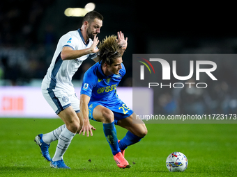 Lorenzo Colombo of Empoli FC and Stefan de Vrij of FC Internazionale compete for the ball during the Serie A Enilive match between Empoli FC...