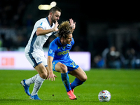 Lorenzo Colombo of Empoli FC and Stefan de Vrij of FC Internazionale compete for the ball during the Serie A Enilive match between Empoli FC...