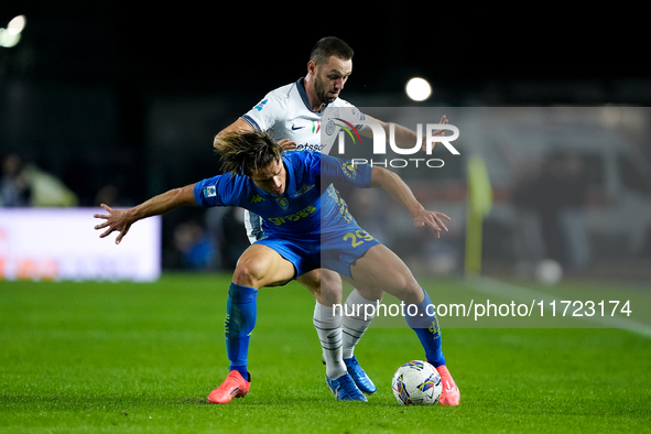 Lorenzo Colombo of Empoli FC and Stefan de Vrij of FC Internazionale compete for the ball during the Serie A Enilive match between Empoli FC...