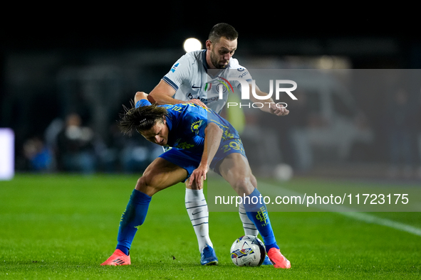 Lorenzo Colombo of Empoli FC and Stefan de Vrij of FC Internazionale compete for the ball during the Serie A Enilive match between Empoli FC...