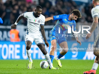 Saba Goglichidze of Empoli FC commits the red card foul on Marcus Thuram of FC Internazionale during the Serie A Enilive match between Empol...