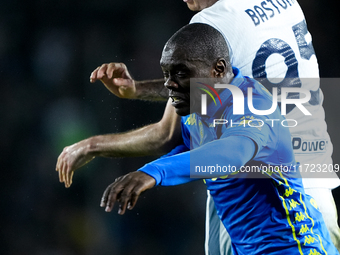 Alessandro Bastoni of FC Internazionale and Emmanuel Gyasi of Empoli FC jump for the ball during the Serie A Enilive match between Empoli FC...