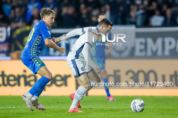 Piotr Zielinski of FC Internazionale and Jacopo Fazzini of Empoli FC compete for the ball during the Serie A Enilive match between Empoli FC...