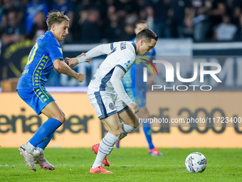 Piotr Zielinski of FC Internazionale and Jacopo Fazzini of Empoli FC compete for the ball during the Serie A Enilive match between Empoli FC...