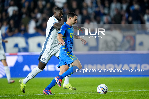 Marcus Thuram of FC Internazionale and Mattia De Sciglio of Empoli FC compete for the ball during the Serie A Enilive match between Empoli F...