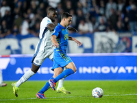 Marcus Thuram of FC Internazionale and Mattia De Sciglio of Empoli FC compete for the ball during the Serie A Enilive match between Empoli F...