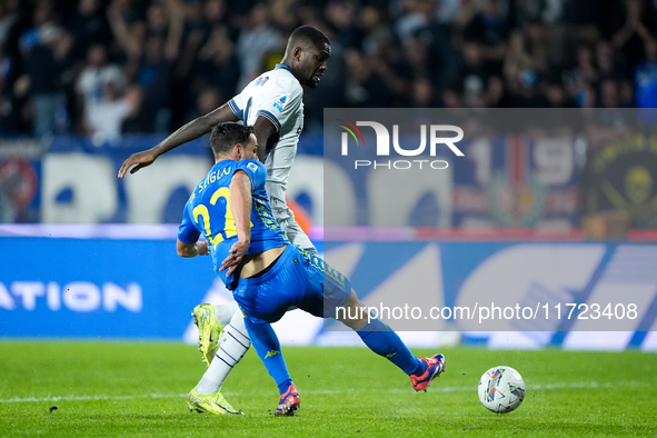 Marcus Thuram of FC Internazionale and Mattia De Sciglio of Empoli FC compete for the ball during the Serie A Enilive match between Empoli F...