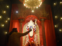 People take selfies on their mobile phones inside a pandal, or temporary platform, of the Kali Puja festival in Kolkata, India, on October 3...