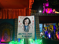 A poster about the rape and murder case of a doctor from R G Kar Medical College and Hospital is seen at a pandal during the Kali Puja festi...