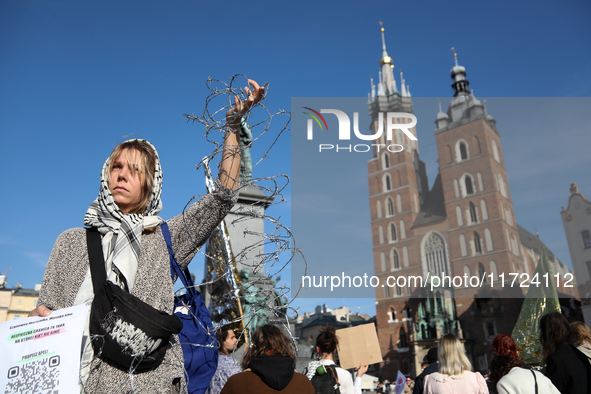 Participants in a protest against the suspension of asylum law under the slogan 'Fuck your borders' gather at the Main Square in Krakow, Pol...