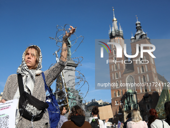 Participants in a protest against the suspension of asylum law under the slogan 'Fuck your borders' gather at the Main Square in Krakow, Pol...