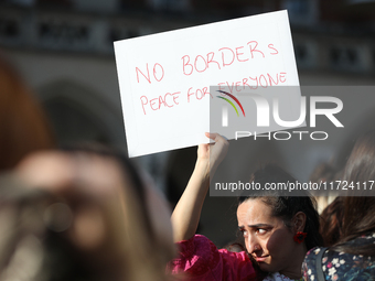 Participants in a protest against the suspension of asylum law under the slogan 'Fuck your borders' gather at the Main Square in Krakow, Pol...