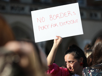 Participants in a protest against the suspension of asylum law under the slogan 'Fuck your borders' gather at the Main Square in Krakow, Pol...