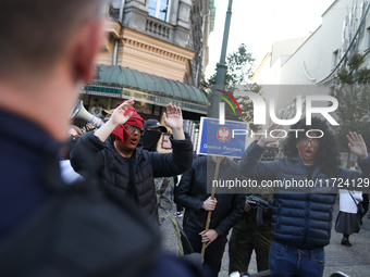 Participants of the counter-demonstration organized by the All-Polish Youth dress as refugees in blackface, and Polish soldiers point rifles...