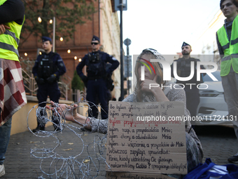 Participants protest against the suspension of asylum law under the slogan 'Fuck your borders' outside the Civic Platform office in Krakow,...