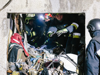 Rescuers work at the site of debris removal, following a Russian airstrike in Kharkiv, Ukraine, on October 30, 2024, a bomb struck a residen...