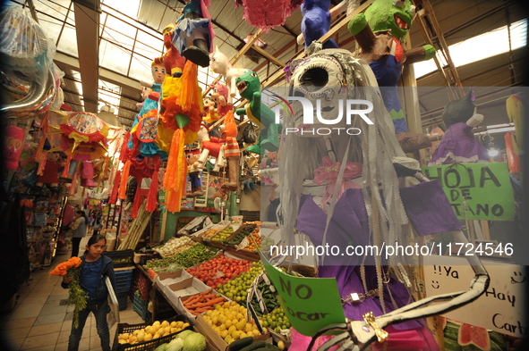 A cardboard skull is seen at a market in the municipality of San Juan del Rio. Local market vendors offer items to decorate the offerings, s...