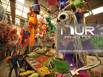 A cardboard skull is seen at a market in the municipality of San Juan del Rio. Local market vendors offer items to decorate the offerings, s...