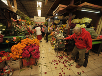 A vendor offers cempasuchil flowers inside a market in the municipality of San Juan del Rio. Local market vendors offer items to decorate th...