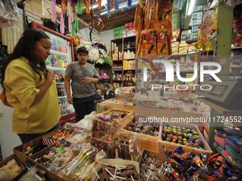 A person shops for chocolate skulls inside a market in the municipality of San Juan del Rio. Local market vendors offer items to decorate th...