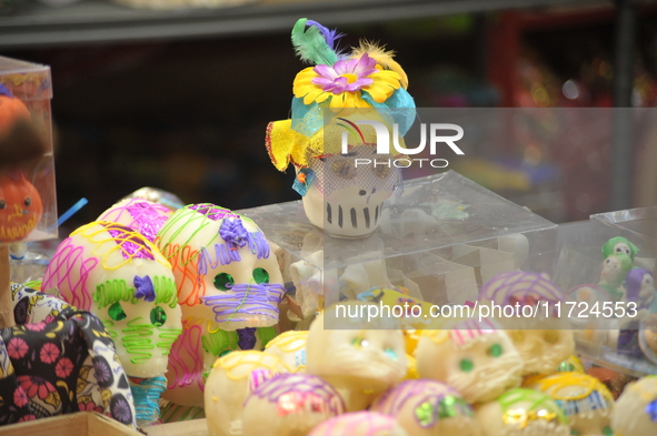 Sugar skulls, known as calaverita de azucar, are seen at a stand inside a market in the municipality of San Juan del Rio. Local market vendo...