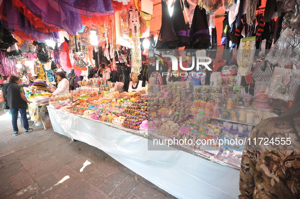 Sugar skulls, known as calaverita de azucar, are seen at a stand inside a market in the municipality of San Juan del Rio. Local market vendo...