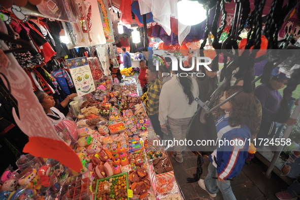 A vendor offers sugar skulls known as calaverita de azucar inside a market in the municipality of San Juan del Rio. Local market vendors off...