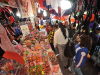 A vendor offers sugar skulls known as calaverita de azucar inside a market in the municipality of San Juan del Rio. Local market vendors off...