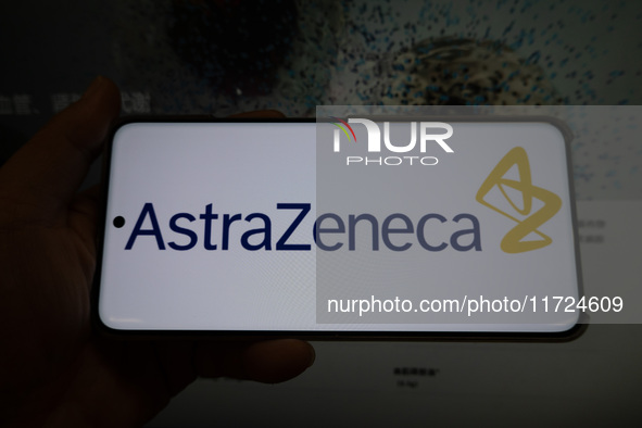 The corporate logo and official website of AstraZeneca are displayed in Shanghai, China, on October 31, 2024. 