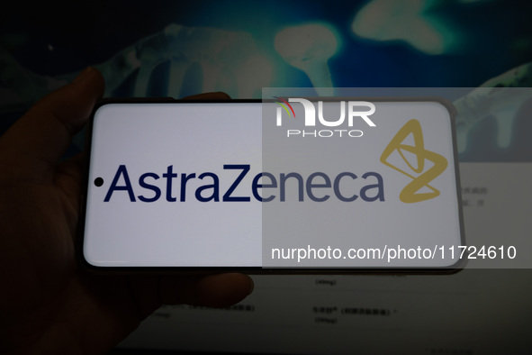 The corporate logo and official website of AstraZeneca are displayed in Shanghai, China, on October 31, 2024. 