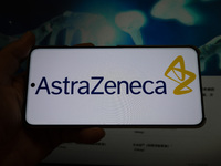 The corporate logo and official website of AstraZeneca are displayed in Shanghai, China, on October 31, 2024. (