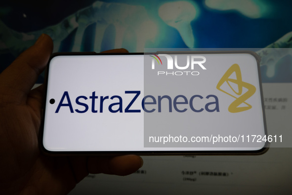 The corporate logo and official website of AstraZeneca are displayed in Shanghai, China, on October 31, 2024. 